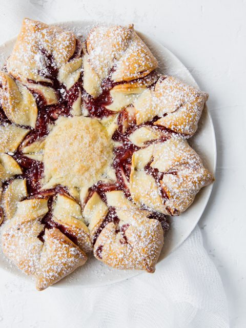 Overhead shot of a grain-free holiday star bread with raspberry filling.